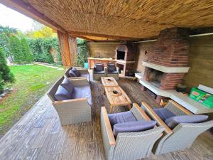 a patio with couches and a table and a fireplace at Montenegro Royal 2 Bedroom Apartment in Bečići +16 photos