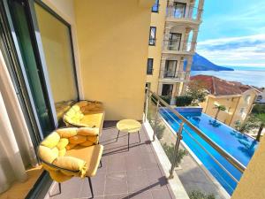 a balcony with a view of a swimming pool at Montenegro Royal 2 Bedroom Apartment in Bečići
