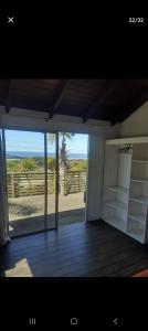 a room with an open door with a view of the beach at La posta de corumba in La Paloma