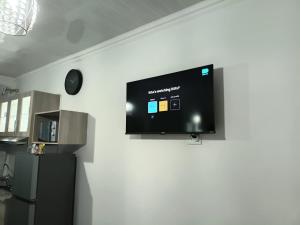 a flat screen tv hanging on a wall at 27 on Donaldbain in Welkom