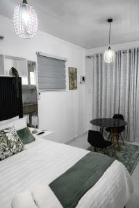 a bedroom with a large bed and a table at 27 on Donaldbain in Welkom