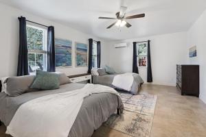 a bedroom with two beds and a ceiling fan at Pampered Pillow in Canyon Lake