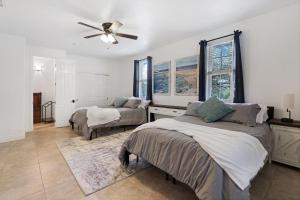 a bedroom with two beds and a ceiling fan at Pampered Pillow in Canyon Lake +27 photos