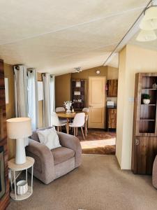 a living room with a couch and a table at Edinburgh Lux Lodge Seton Sands in Port Seton