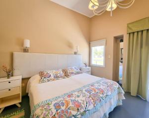 a bedroom with a large bed and a window at Complejo Aquiles in Lobos +28 photos