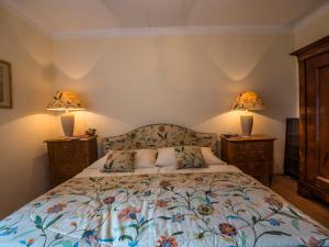 a bedroom with a bed with two lamps on it at Apartment "Maria Theresia" in Graz