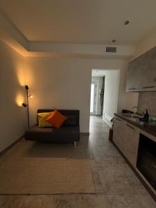 a living room with a couch and a kitchen at R Apartment - Venaria in Venaria Reale
