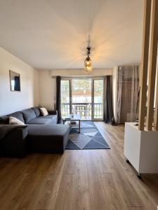 a living room with a couch and a table at Studio Cosy in Mimizan-Plage