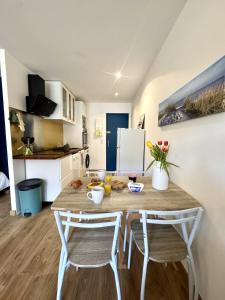 a small kitchen with a table and two chairs at Studio Cosy in Mimizan-Plage