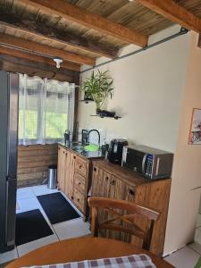 a kitchen with a counter with a microwave on it at Casa Aconchegante in Pomerode