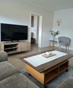 a living room with a tv and a coffee table at Ferienhaus Wasserkunst in Wernigerode