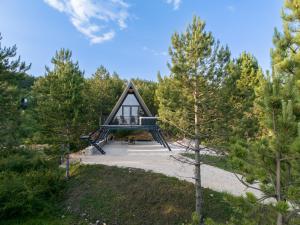 a frame cabin in the woods with trees at Continental Adventure Resort - Mountain Escape & Glamping in Livno