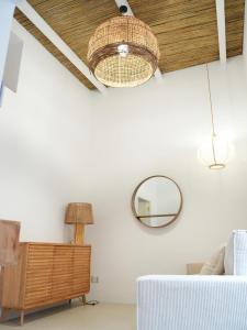 a living room with a couch and a mirror at Maison Begani66 in Gaeta