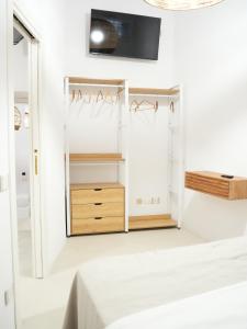 a bedroom with white walls and a mirror at Maison Begani66 in Gaeta +12 photos
