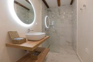 a bathroom with a sink and a mirror at Magna in Dobropoljana +59 photos