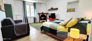 a bedroom with a bed and a chair at Joly's Home in Luco neʼ Marsi