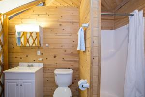 a wooden bathroom with a toilet and a sink at Yosemite Lakes Yurts in Harden Flat +28 photos