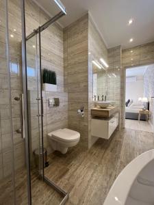 a bathroom with a toilet and a sink at Milano Vendégház in Bakonybél +19 photos