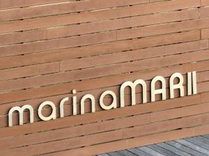 a sign on a wooden wall with the word mariani at Marina Mar II - Moradia T3 in Vila Franca do Campo