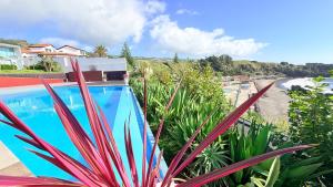 a swimming pool with a view of the ocean at Marina Mar II - Moradia T3 in Vila Franca do Campo