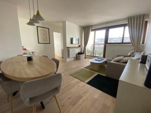 a living room with a table and a couch at Eiffel Tower View & Pool in Paris