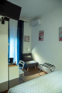 a bedroom with a bed and a chair and a desk at Albergo La Marinella in Varazze