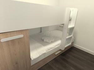 a small white bunk bed in a room at Apartamento Eguzkey - Tolosa centro in Tolosa