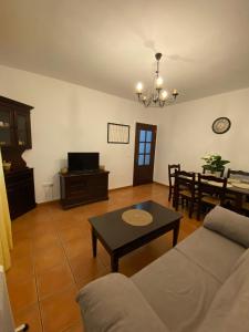 a living room with a couch and a table at Apartamento Tarramilla in Prado del Rey