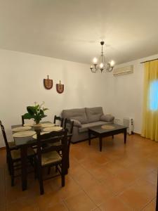 a living room with a table and a couch at Apartamento Tarramilla in Prado del Rey