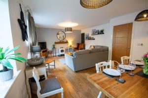 a living room with a couch and a table at Pine Cones in Rhoscolyn