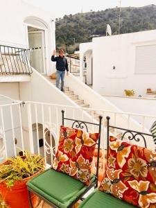 a man walking down the stairs on a balcony at Casa Maddy Anacapri in Anacapri