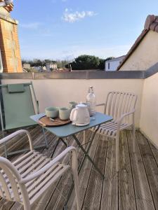 a table and two chairs on a balcony at Escale à Clisson - Les jardins de Bali in Clisson