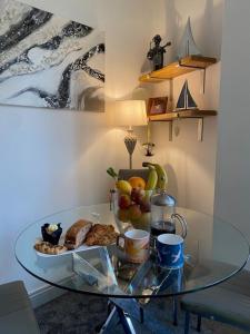 a glass table with a plate of fruit on it at 5 Sea Spray in Burnham on Sea