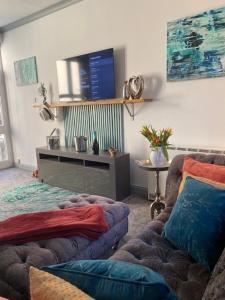 a living room with two couches and a tv at 5 Sea Spray in Burnham on Sea