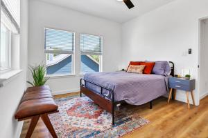 a bedroom with a bed and a rug and two windows at Pitch Perfect in Canyon Lake