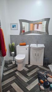 a bathroom with a white toilet and a sink at 5 Sea Spray in Burnham on Sea +25 photos