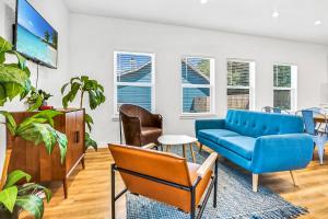 a living room with a blue couch and chairs at Pitch Perfect in Canyon Lake
