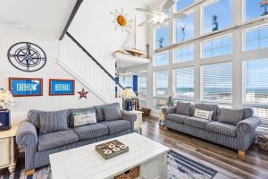 a living room with two couches and a table at 4000 - Fragile Magic in Kitty Hawk