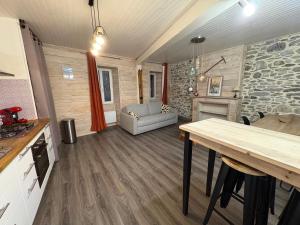 a kitchen and living room with a table and a couch at Appartement la Tûte centre Laruns in Laruns