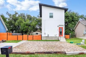 a white house with a red door at Pitch Perfect in Canyon Lake