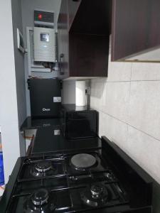 a kitchen with a stove top oven in a kitchen at DailyPunch Apartment in Kitwe