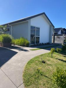a house with a driveway in front of it at Sea Escape in Whitianga