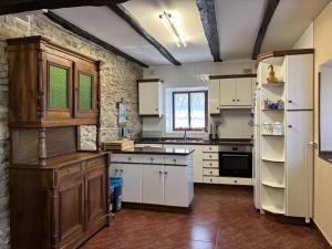a large kitchen with white cabinets and a refrigerator at Caserio Uletza in Rigoitia