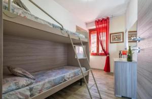 a bedroom with a bunk bed and a window at Relax House & Gym in Villanova Monteleone