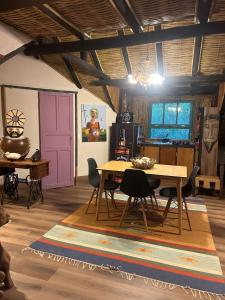 a dining room with a wooden table and chairs at Chalé - Refúgio Serra das Águas in Araras Petropolis