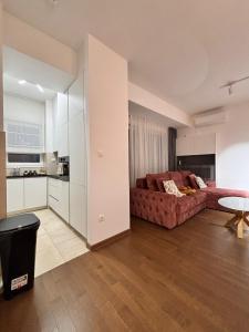 a living room with a couch and a kitchen at Tower II in Banja Luka