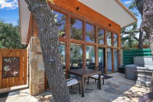 a glass house with a table and a grill at Windmill Ranch - Terra Casita #2 in Wimberley +21 photos