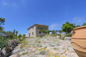 an old building on top of a hill with flowers at Villa Katerina in Chania