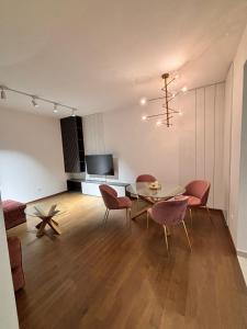 a living room with a table and chairs and a television at Tower II in Banja Luka