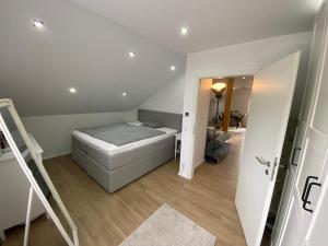 a small bedroom with a bed and a staircase at Pribe in Reiskirchen